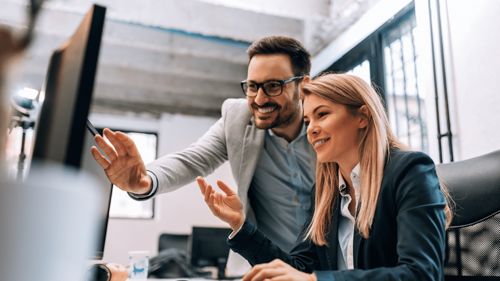 managed service provider (msp) - man and woman gesture excitedly in front of computer