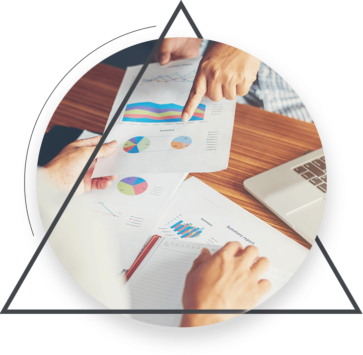 hands pointing to graphs on papers - Alberta IT business strategy