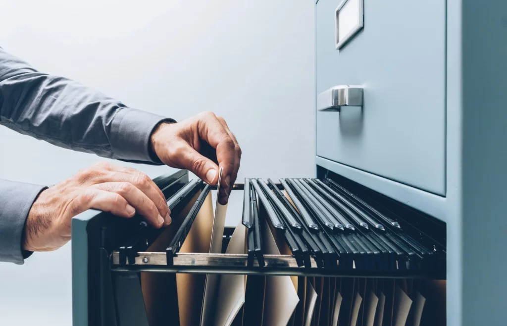 hands sifting through filing cabinet - secure data storage