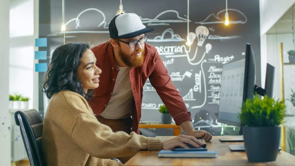 onboarding new employees with security - man and woman working at desk