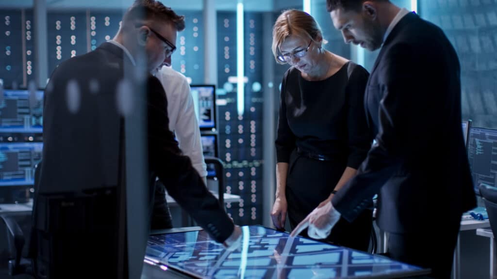 creating a cybersecurity plan - IT team gathered around table