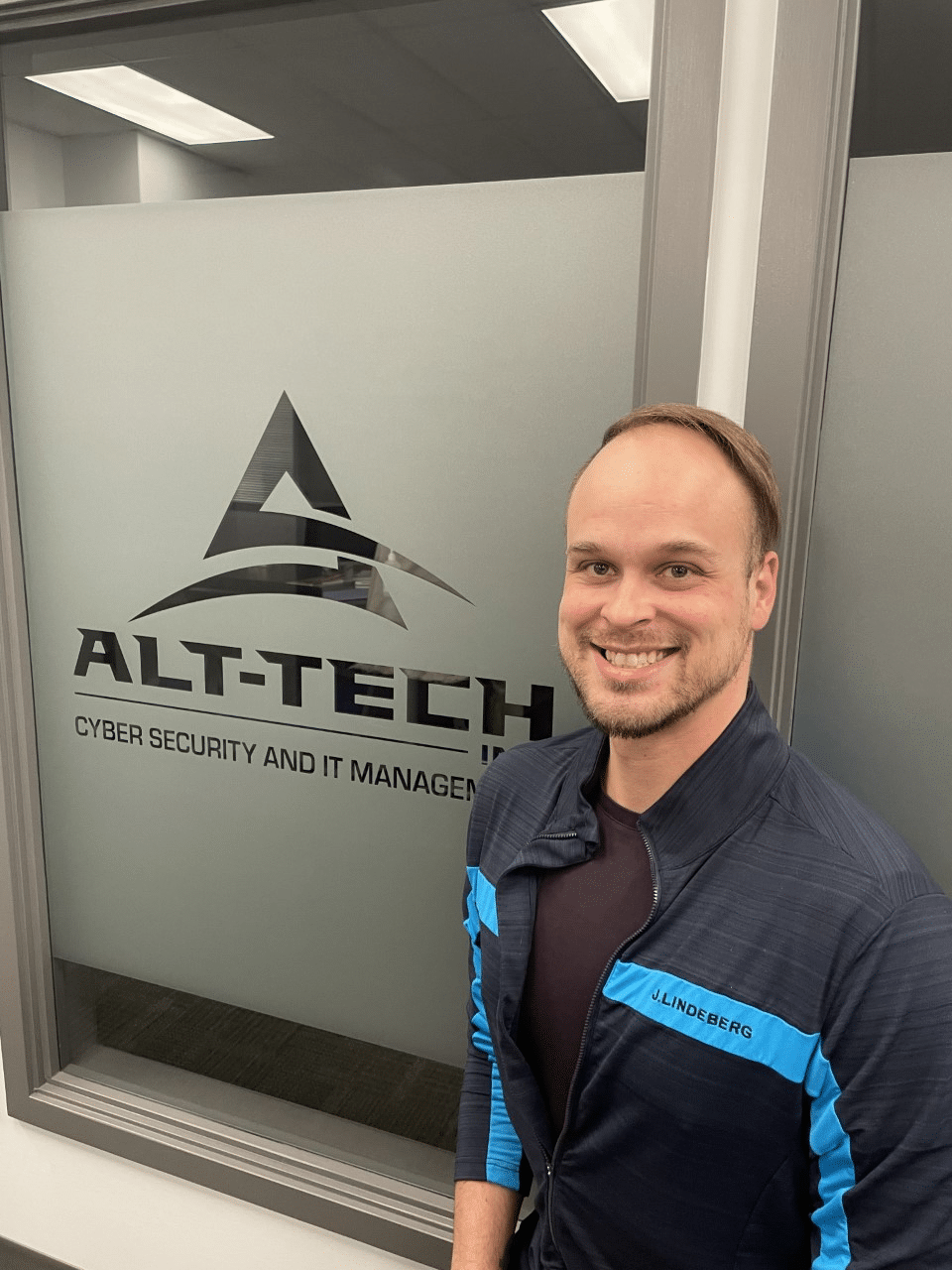 Brett smiling next to alt-tech logo